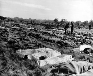 Hundreds of dead soldiers in stretchers covered with a blankets after D-Day. Killed during Normandy landings, they lie in a temporary cemetery on the cliff of Colleville-sur-Mer, overlooking Omaha Beach, ca. June 8-10, 1944. This scene took place a little west of the permanent Normandy American Cemetery and Memorial. France, World War 2. (BSLOC_2014_2_43) (Newscom TagID: evhistorypix026772.jpg) [Photo via Newscom]